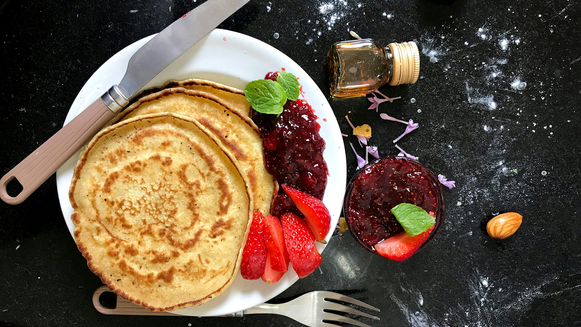 Fluffy pancakes and with strawberries and strawberry jam
